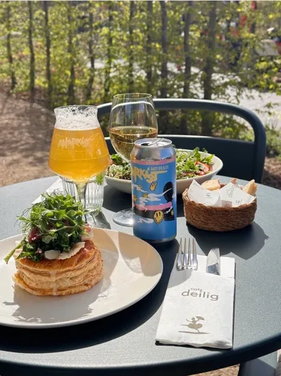 Tartlets, beer and salad at a table in the garden