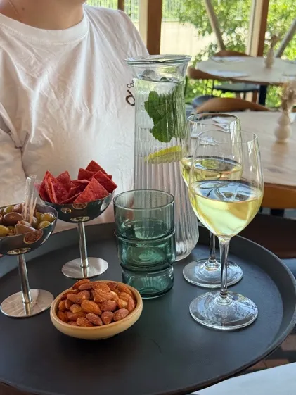 Tray with olives, crisps, nuts and white wine